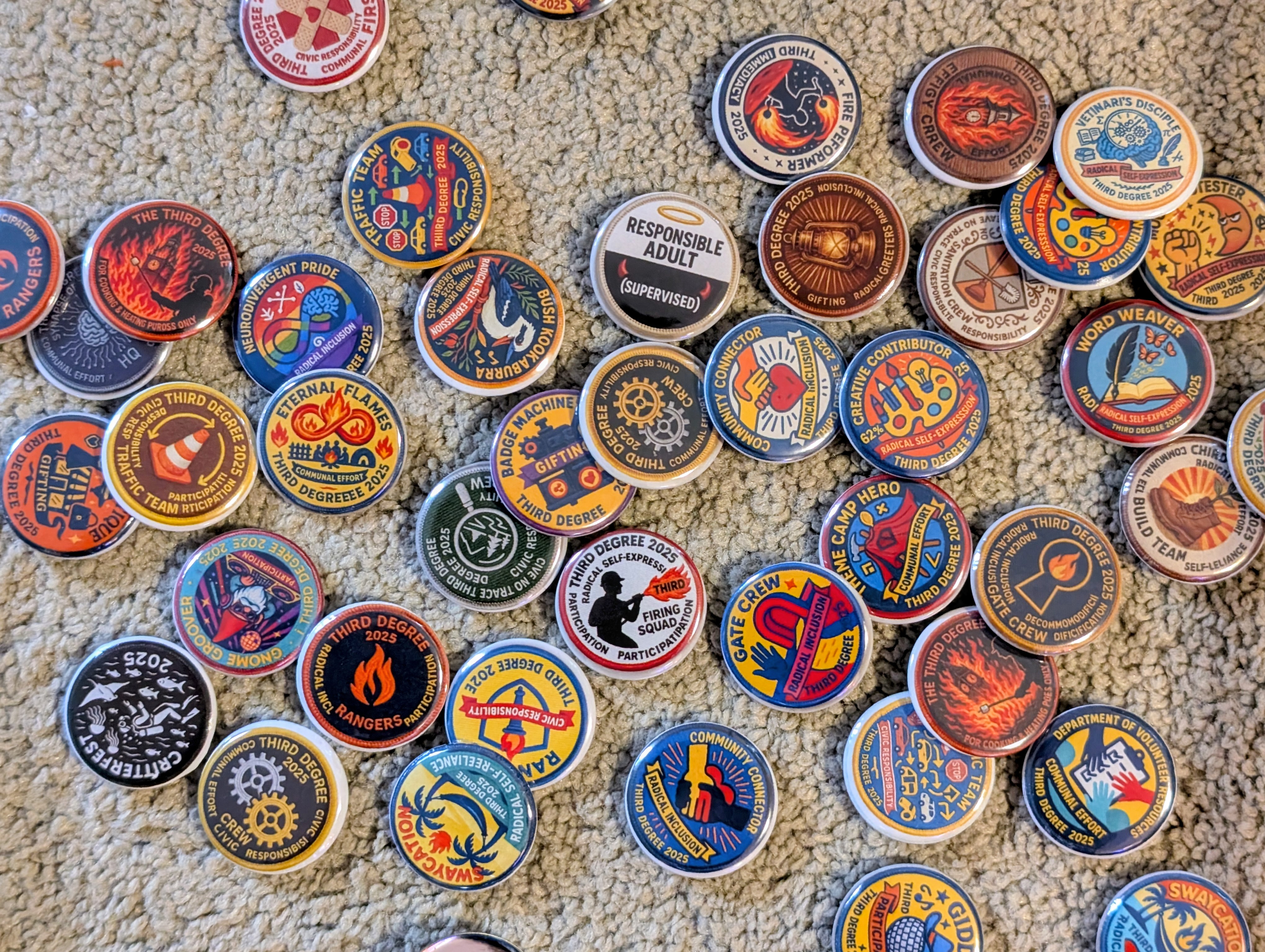 Collection of Third Degree Burn 2025 badges showing 60 unique designs representing volunteer teams, theme camps, art installations, wildlife, and community roles